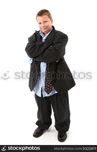 Handsome american ten year old boy in oversized suit with arms crossed.