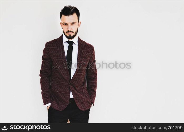 Handsome and elegant fashionable man or businessman posing a white background