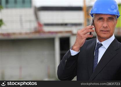 handsome architect making a call in construction site