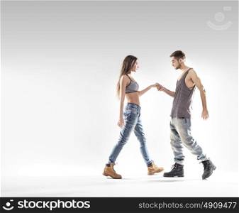 Handsome b-boy dancing with a slim, attractive girl