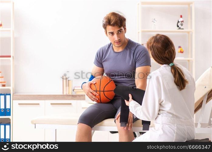 Handsome basketball player visiting female doctor traumatologist   . Handsome basketball player visiting female doctor traumatologist