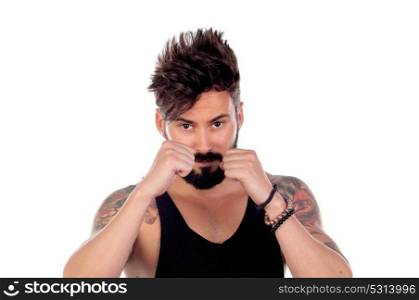 Handsome bearded man with tattoos on his body showing the fists