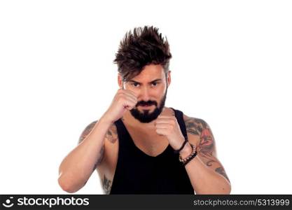 Handsome bearded man with tattoos on his body showing the fists