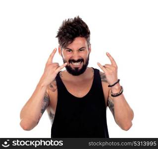 Handsome bearded man with tattoos on his body showing the symbol of heavy metal rock
