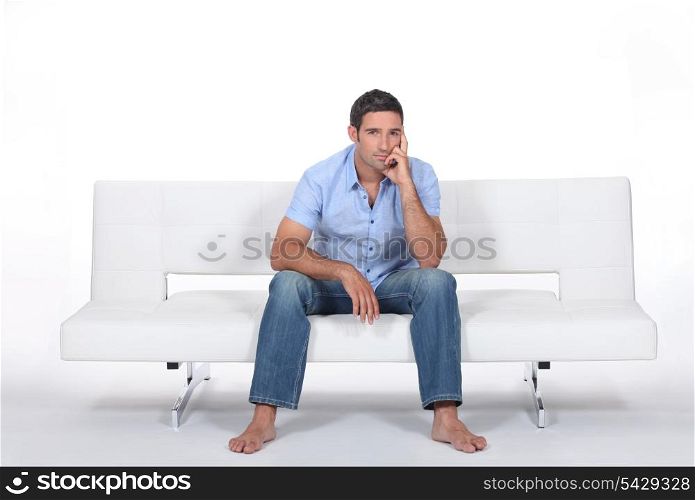 handsome bloke sitting on sofa