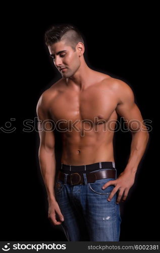 Handsome bodybuilder with a great body posing over a copy space background