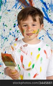 Handsome boy playing with painting with the background painted