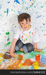 Handsome boy playing with painting with the background painted