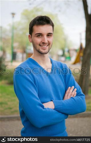 Handsome boy with blue jersey relaxing in a park