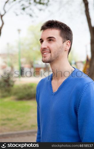 Handsome boy with blue jersey relaxing in a park