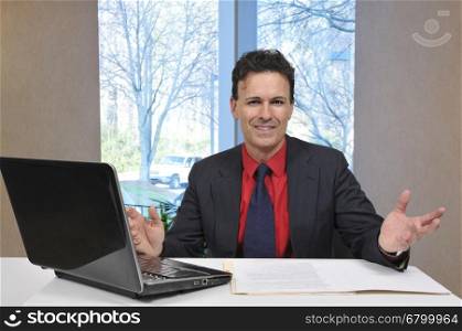 Handsome business man banker or salesman with a computer