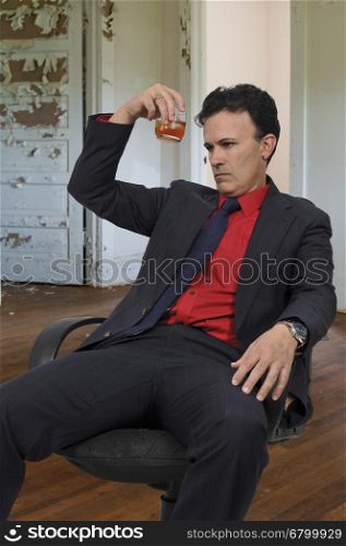 Handsome business man holding an alcoholic drink