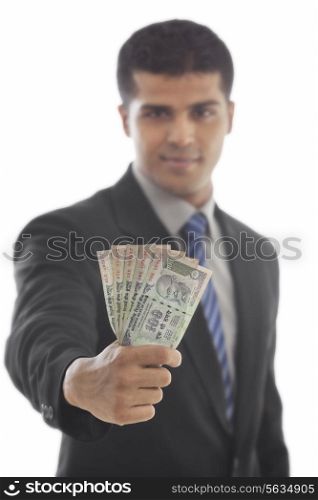 Handsome business man holding Indian currency