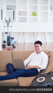 handsome business man in casual clothing working on laptop computer from home and drink firs morning coffee