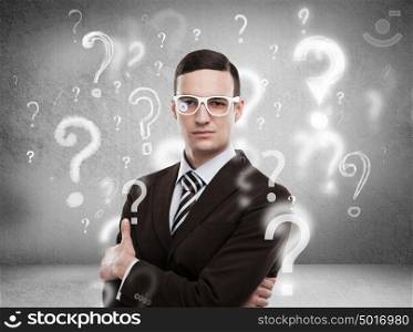 Handsome business man with question marks above his head