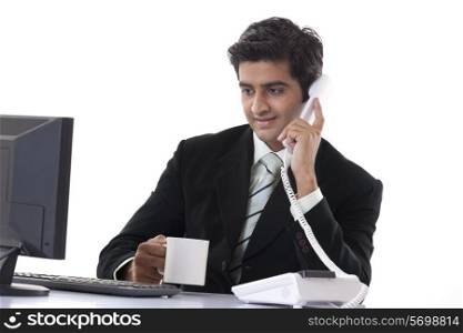 Handsome businessman busy working while having coffee