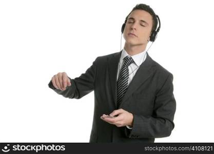 Handsome businessman dancing hearing music with headphones
