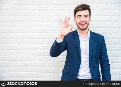 Handsome Businessman doing okay or alright gesture. Business and success concept. People and Portrait theme.