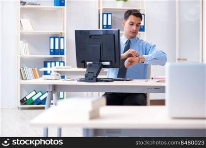 Handsome businessman employee sitting at his desk in office