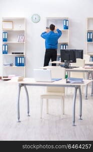 Handsome businessman employee sitting at his desk in office