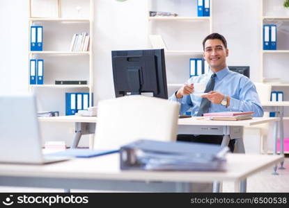 Handsome businessman employee sitting at his desk in office