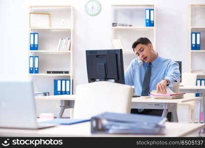 Handsome businessman employee sitting at his desk in office