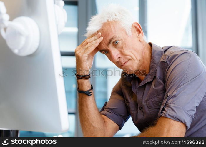 Handsome businessman in office. Handsome businessman in casual wear working in office