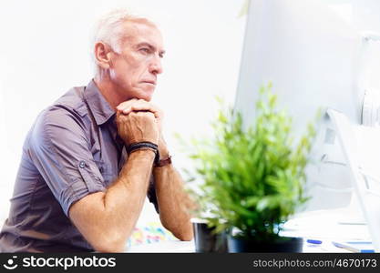 Handsome businessman in office. Handsome businessman in casual wear working in office