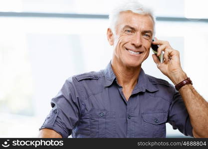 Handsome businessman in office. Handsome businessman in casual wear working in office