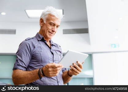 Handsome businessman in office. Handsome businessman in casual wear working in office