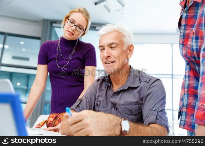 Handsome businessman in office. Handsome businessman in casual wear working in office