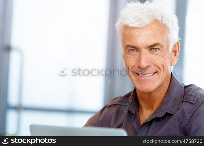 Handsome businessman in office. Handsome businessman in casual wear working in office