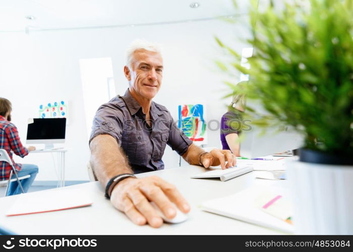 Handsome businessman in office. Handsome businessman in casual wear working in office