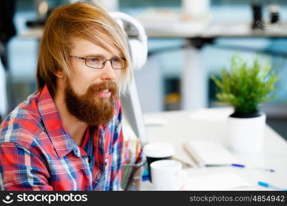 Handsome businessman in office. Handsome businessman in casual wear working in office