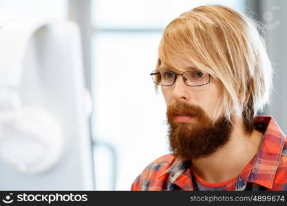 Handsome businessman in office. Handsome businessman in casual wear working in office