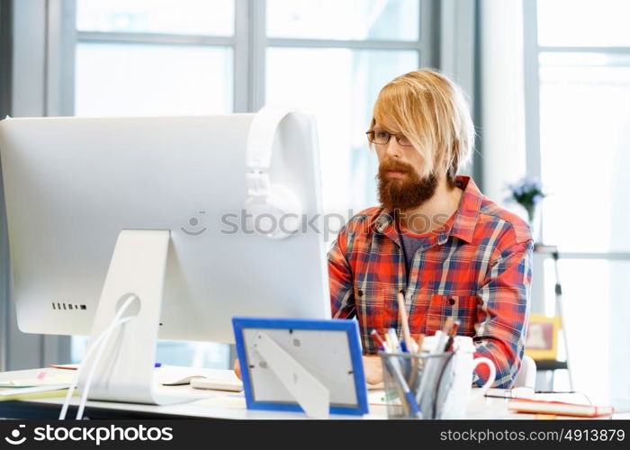 Handsome businessman in office. Handsome businessman in casual wear working in office