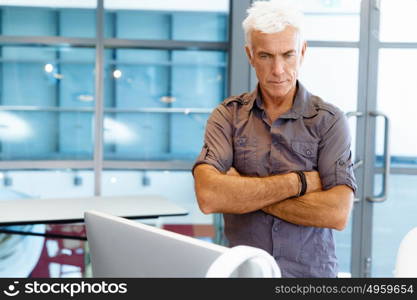 Handsome businessman in office. Handsome businessman in casual wear working in office