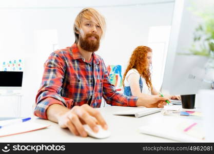 Handsome businessman in office. Handsome businessman in casual wear working in office