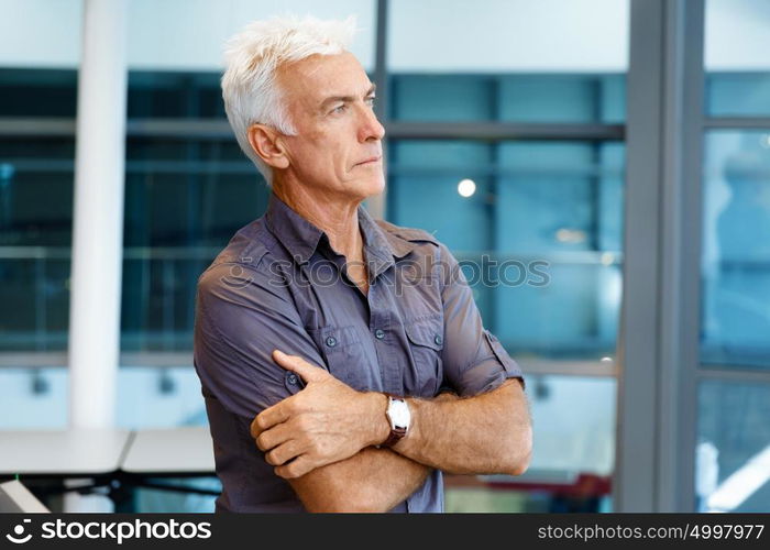 Handsome businessman in office. Handsome businessman in casual wear working in office