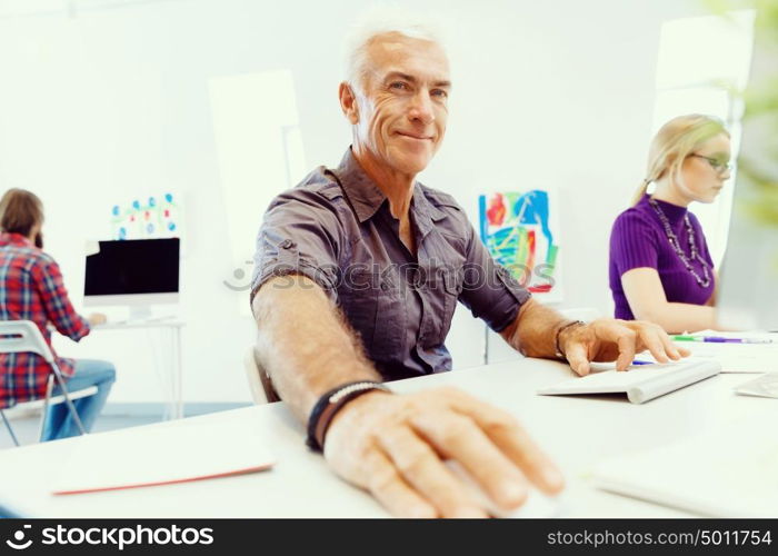 Handsome businessman in office. Handsome businessman in casual wear working in office