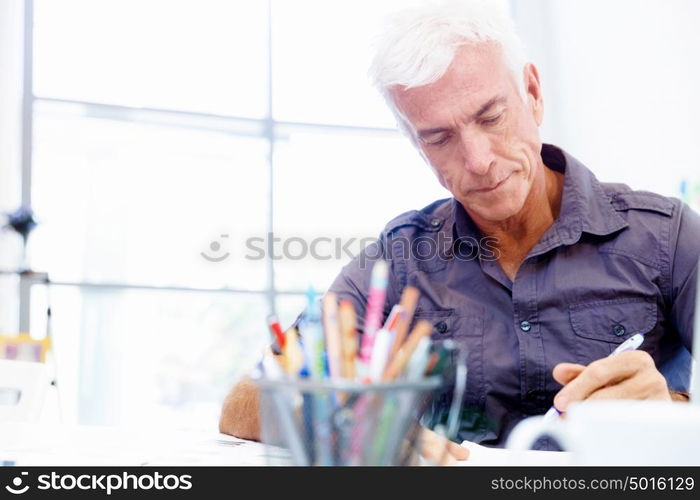 Handsome businessman in office. Handsome businessman in casual wear working in office