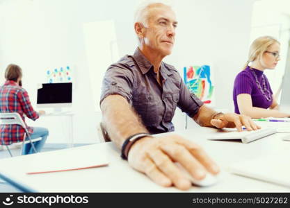 Handsome businessman in office. Handsome businessman in casual wear working in office