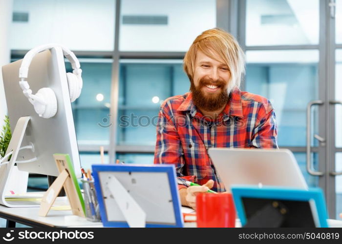 Handsome businessman in office. Handsome businessman in casual wear working in office