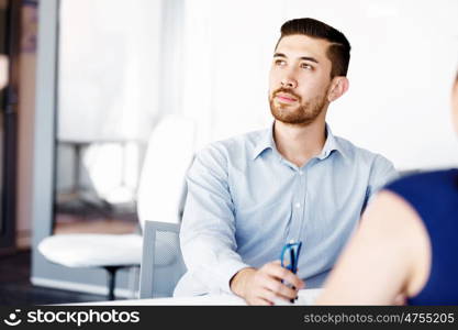 Handsome businessman in office. Handsome businessman in office sitting at desk