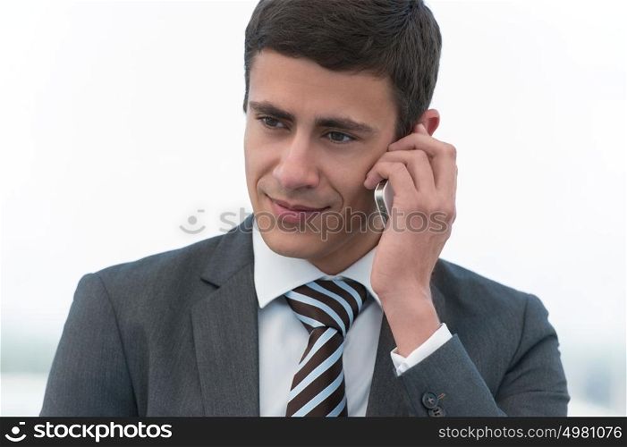 Handsome businessman in suit speaking on the phone
