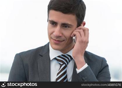 Handsome businessman in suit speaking on the phone