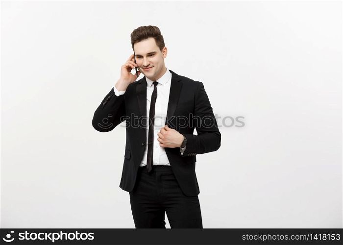 Handsome businessman in suit speaking on the phone over isolated white background. Handsome businessman in suit speaking on the phone over isolated white background.