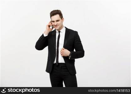 Handsome businessman in suit speaking on the phone over isolated white background. Handsome businessman in suit speaking on the phone over isolated white background.