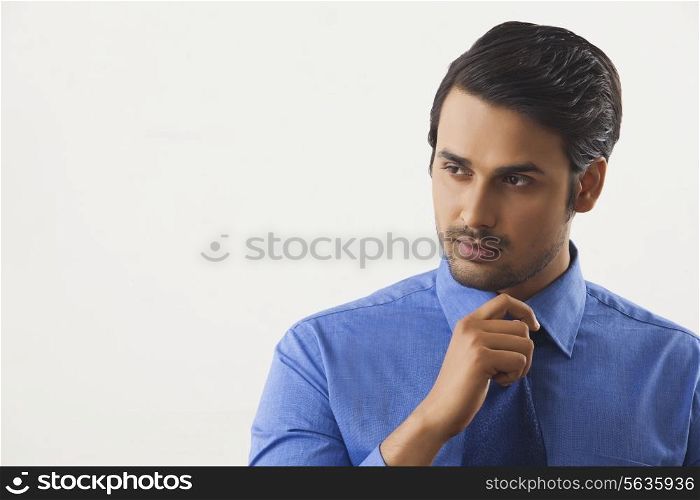 Handsome businessman looking away over white background