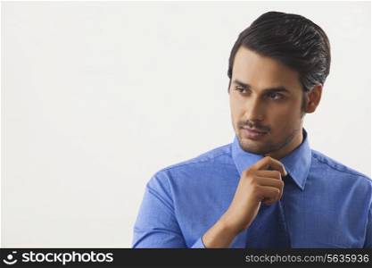 Handsome businessman looking away over white background